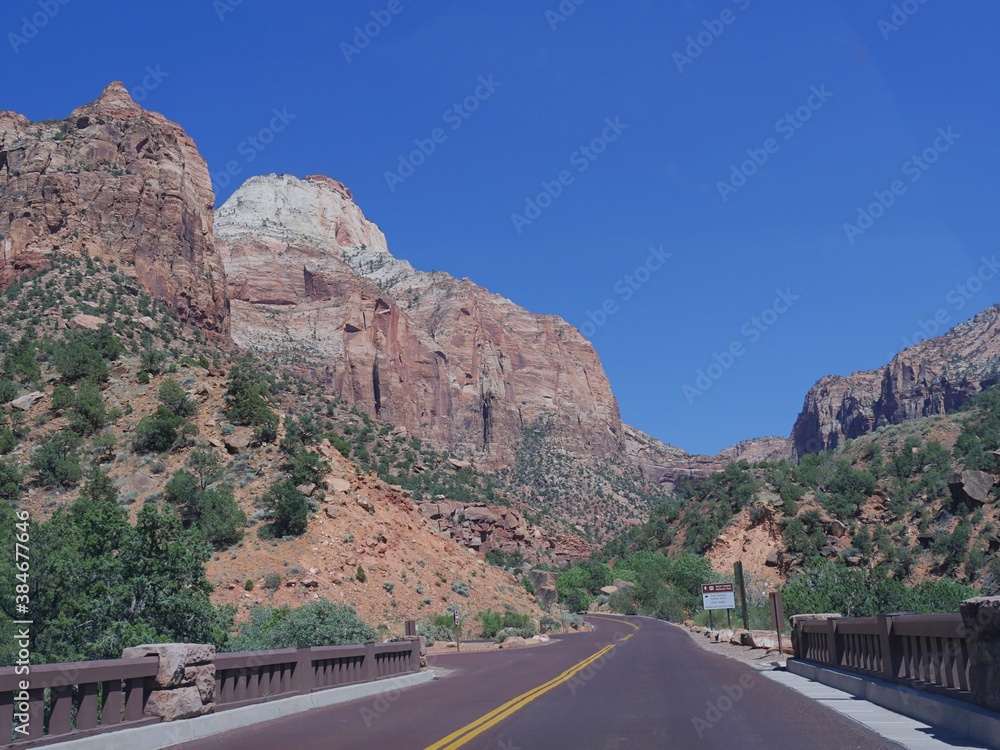 Winding road with breathtaking landscape and mountain peaks at Zion National Park, Utah, USA. Winding road with breathtaking landscape and mountain peaks at Zion National Park, Utah, USA.