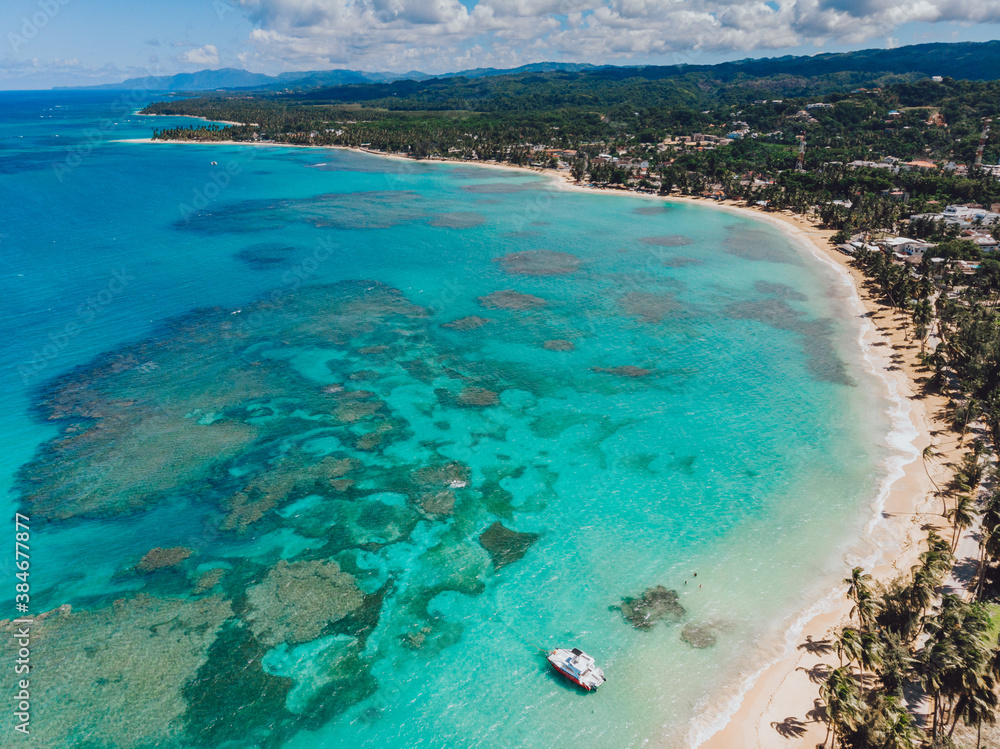Aerial drone panoramic view of the paradise beach with sandy shore, coral spots, palm trees, color boats and blue water of Atlantic Ocean, Las Terrenas, Samana, Dominican Republic Aerial drone panoramic view of the paradise beach with sandy shore, coral spots, palm trees, color boats and blue water of Atlantic Ocean, Las Terrenas, Samana, Dominican Republic