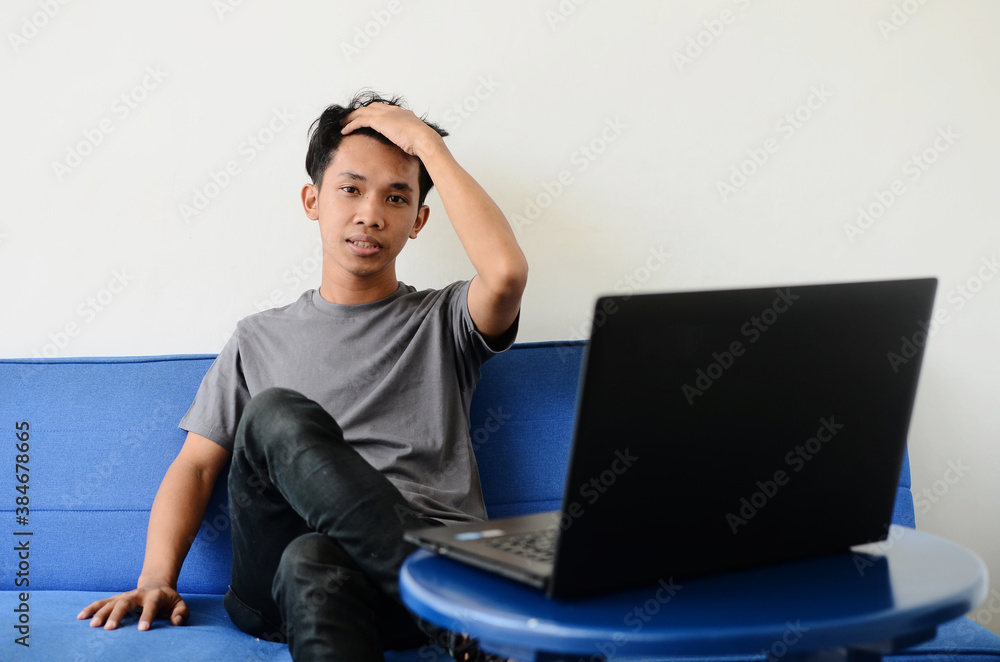 asian man sitting sofa disappointed expression asian man sitting sofa disappointed expression