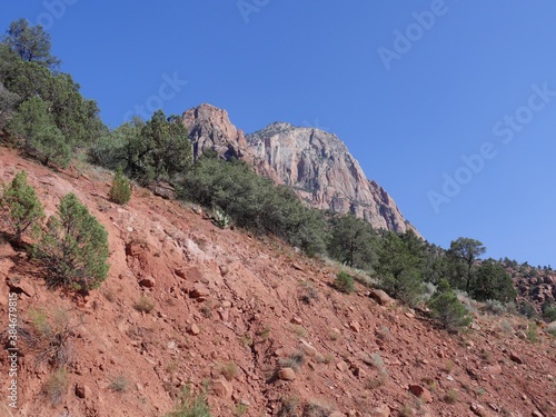 Wide ppward shot of red mountains and sandstone cliffs at Zion National Park, Utah. © raksyBH