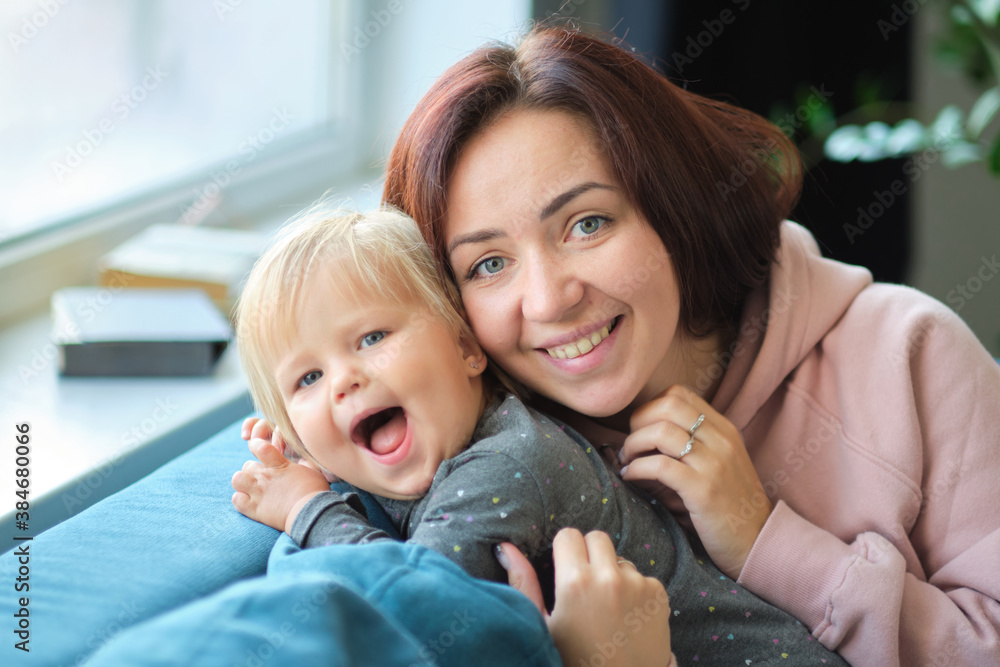 Happy loving family. mother and child girl playing, kissing and hugging