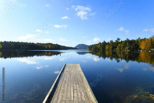 landscape of pier on the quiet lake in autumn