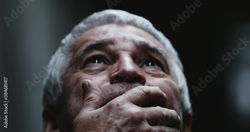 Scared older man covering mouth with hand. Emotional distress. Person in crisis and despair photo