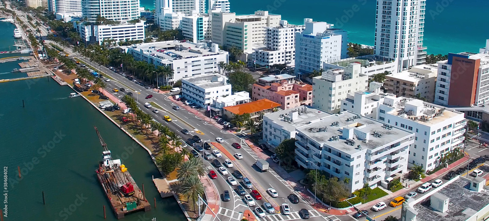 Miami Beach aerial view, Florida from drone viewpoint. Indian Creek and city skyline on a wonderful sunny day, slow motion. - obrazy, fototapety, plakaty 