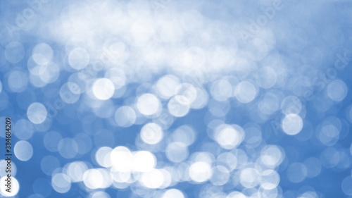 Abstract blue background with white bokeh, winter background