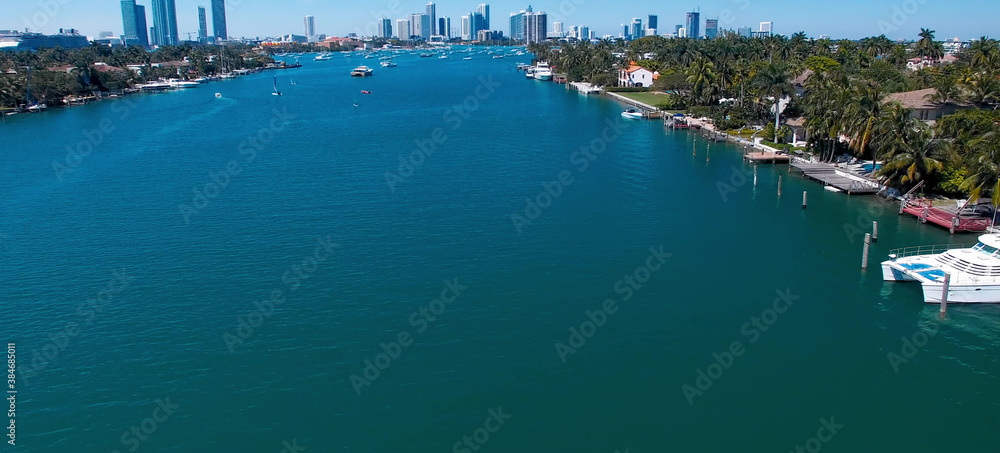 Miami, Florida. Aerial view of Palm Island and surrounding skyline from drone on a sunny day, slow motion. Miami, Florida. Aerial view of Palm Island and surrounding skyline from drone on a sunny day, slow motion.