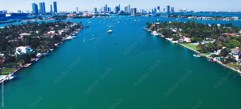 Miami, Florida. Aerial view of Palm Island and surrounding skyline from drone on a sunny day, slow motion.