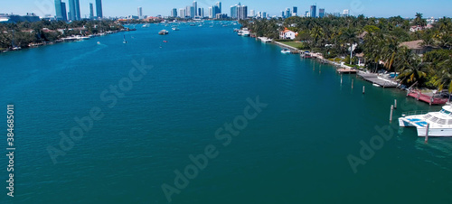Miami, Florida. Aerial view of Palm Island and surrounding skyline from drone on a sunny day, slow motion. © jovannig