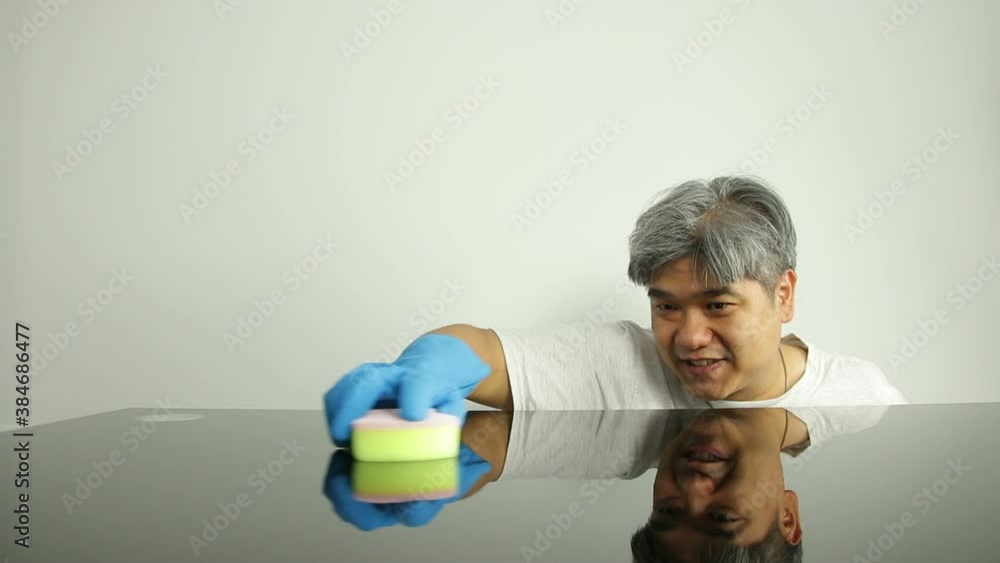 Asian men are cleaning the dining table in the house. Stock ビデオ Adobe