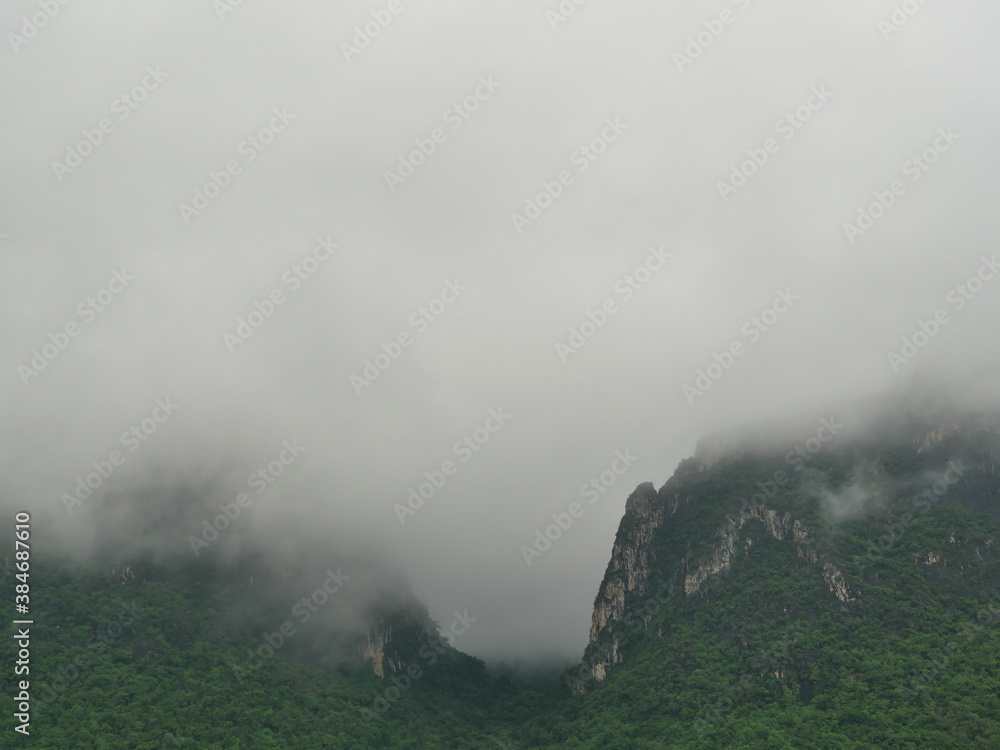 Cloud and fog cover limestone mountain in the rainy season, Green forest and rock at Khao Sam Roi Yot National Park, Thailand Cloud and fog cover limestone mountain in the rainy season, Green forest and rock at Khao Sam Roi Yot National Park, Thailand