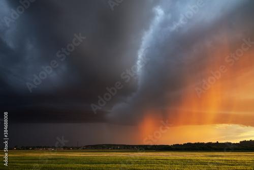 dramatic sunset and rain in a summer field
