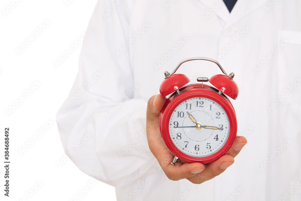 Close-up shot of alarm clock holding in doctor hands Close-up shot of alarm clock holding in doctor hands
