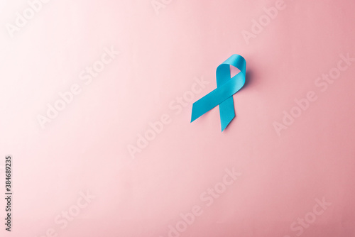 November light blue ribbon, studio shot isolated on pink background, Prostate cancer awareness month, men's health concept photo