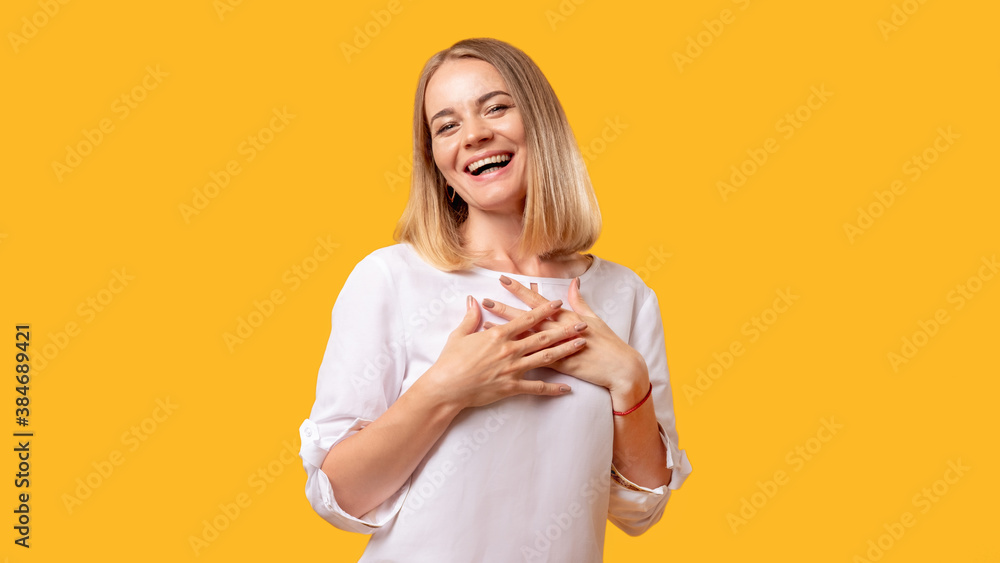 Grateful woman. Surprise greeting. Luck success congratulation. Portrait of astonished impressed happy lady in white looking at camera smiling isolated on orange empty space background. Grateful woman. Surprise greeting. Luck success congratulation. Portrait of astonished impressed happy lady in white looking at camera smiling isolated on orange empty space background.
