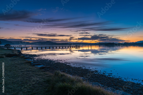 Clouds  reflections and sunrise over the bay