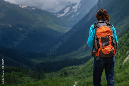 Backpacker on top of a mountain enjoying valley view © YURII Seleznov