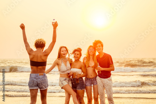 Multi-ethnic group of friends dance at the beach