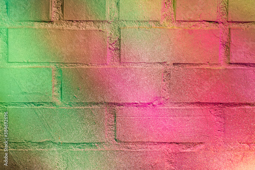 Beautiful bright colorful street art graffiti background. Abstract creative spray drawing fashion colors on the brick walls of the city. Urban Culture gradient texture, copyspace backdrop © Yaroslav