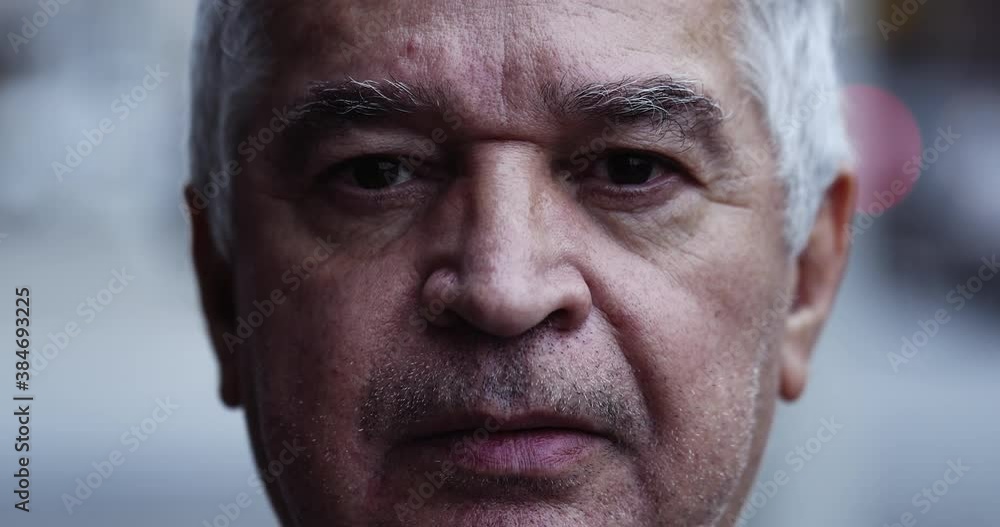 Serious older man portrait looking at camera Serious older man portrait looking at camera