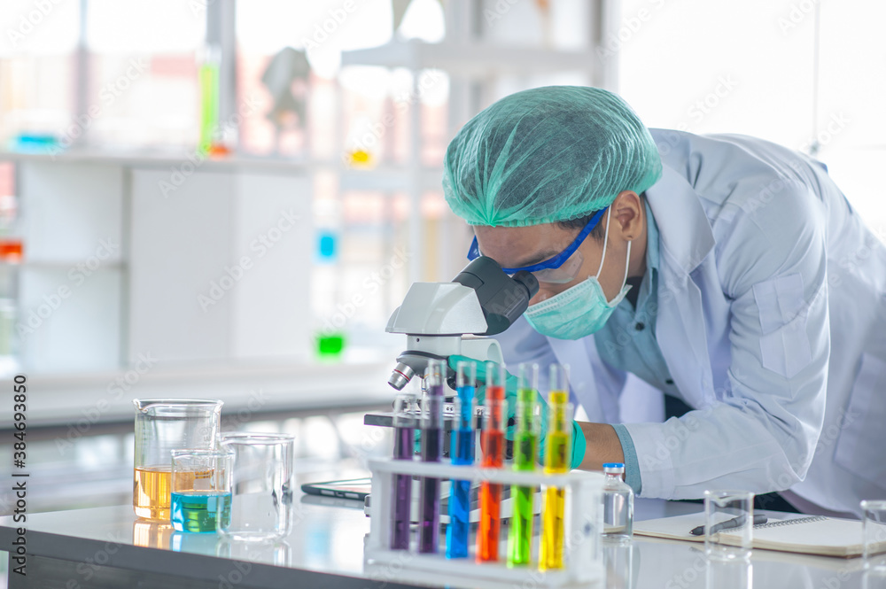 doctor is doing a microscope For research, Vaccine as a treatment for colds, COVID-19 or the coronavirus. doctor is doing a microscope For research, Vaccine as a treatment for colds, COVID-19 or the coronavirus.
