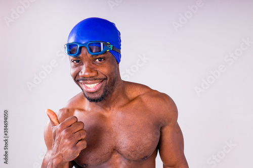 afro latin mixed race man swimmer getting ready to start swimming isolated on white background in studio