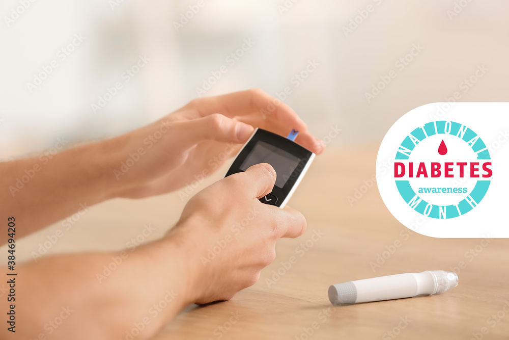 Diabetic man checking blood sugar level at home, closeup. World Diabetes month