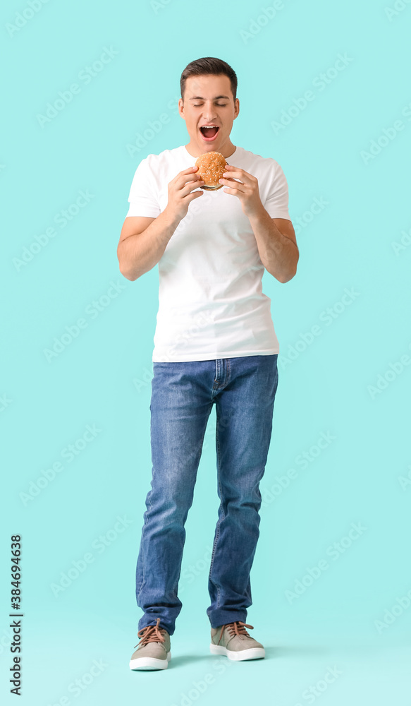 Man with problem of strong hunger on color background. Diabetes symptoms Man with problem of strong hunger on color background. Diabetes symptoms