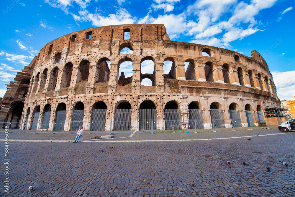 ROME, ITALY - JUNE 2014: The Colosseum and the homonymous square on a summer day