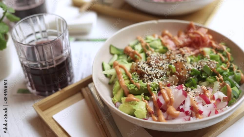 Delicious poke bowl on bamboo tray in hawaiian restaurant Delicious poke bowl on bamboo tray in hawaiian restaurant