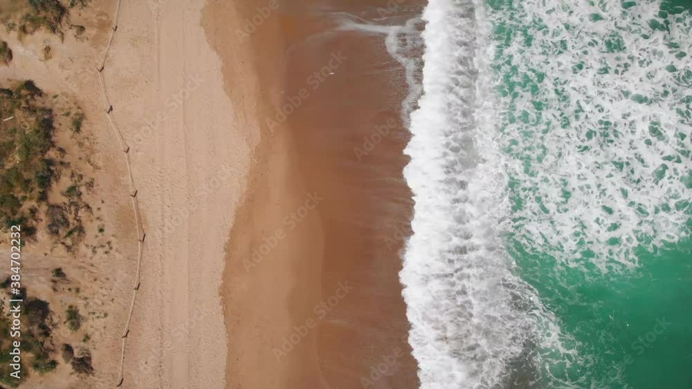 4K Aerial view top down of Beautiful beach with white sand and foaming waves crushing against coast line. Saler Beach, Valencia, Spain 4K Aerial view top down of Beautiful beach with white sand and foaming waves crushing against coast line. Saler Beach, Valencia, Spain