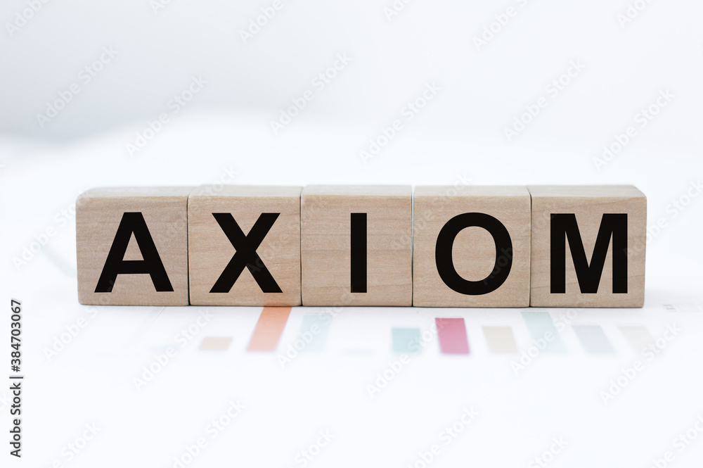 Word Axiom. Wooden small cubes with letters isolated on light background with copy space available. Word Axiom. Wooden small cubes with letters isolated on light background with copy space available.
