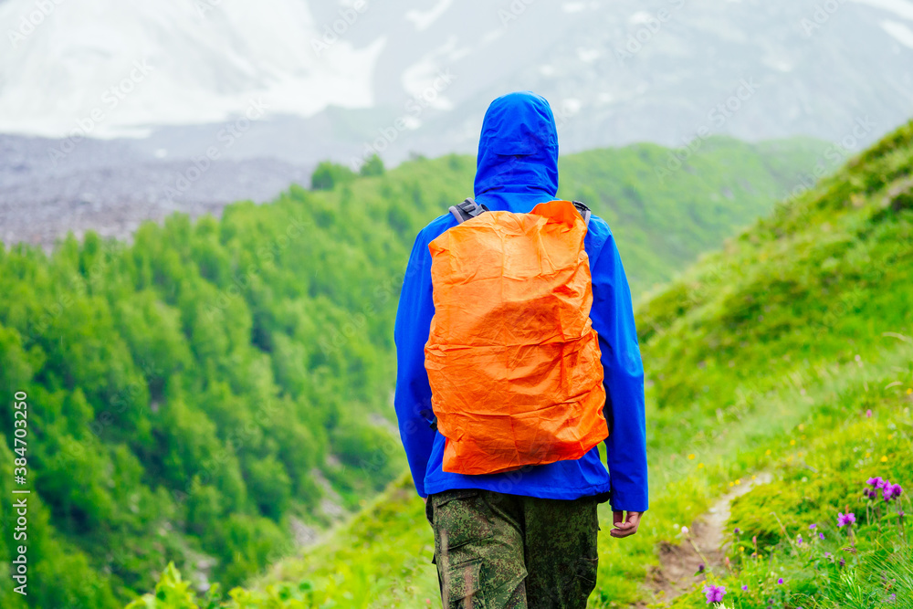 man in blue jacket with rain in mountains man in blue jacket with rain in mountains