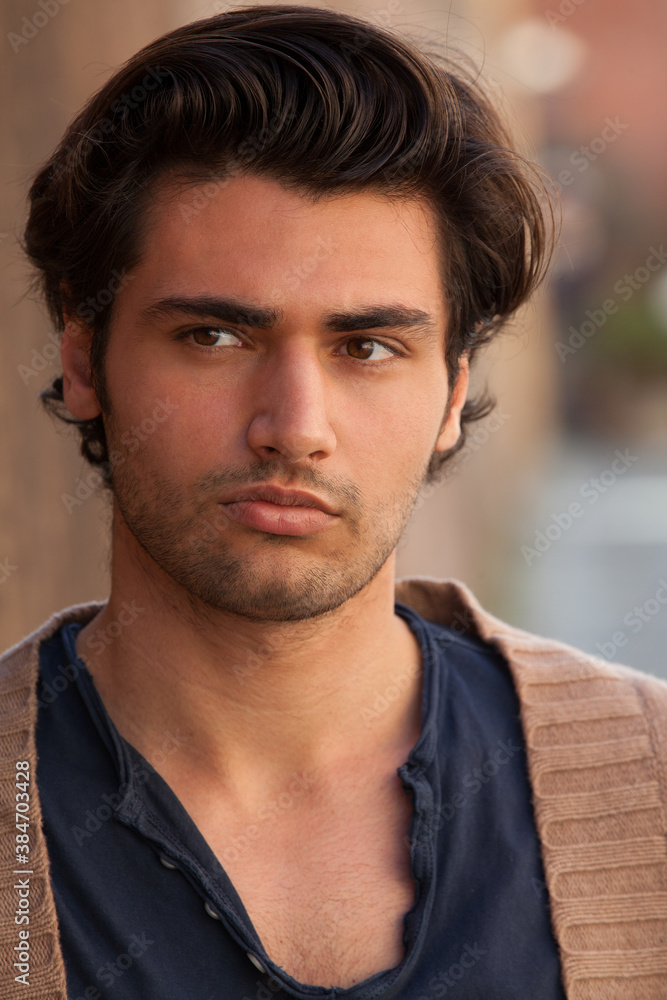 Close portrait of a handsome gorgeous young man with hairstyle. Charming and sensual look. Close portrait of a handsome gorgeous young man with hairstyle. Charming and sensual look.