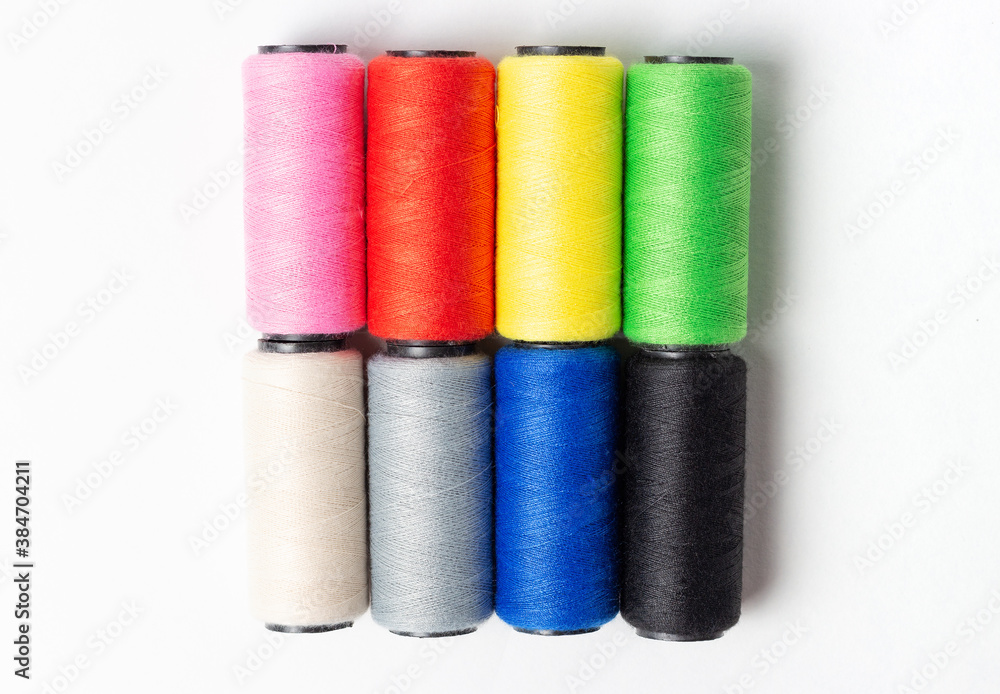 Threads of light dark colors on white background, top view Threads of light dark colors on white background, top view