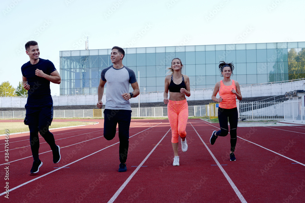 Obraz premium Group running on an athletic track