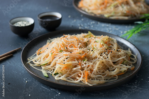 Asian cuisine ,salad funchoza with vegetables on a dark background