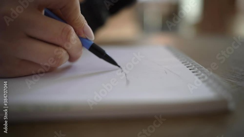 Girl, architect student cafe, sits, sketches, draws sketch, apartment plan white paper, an album, whatman paper mechanical pencil. Apartment, house renovation design project. Furniture placement plan.