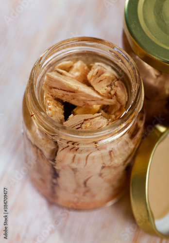 Принти на полотні Preserved bonito tuna fish fillets in glass jar on wooden background