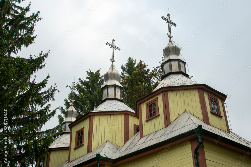 Wooden Orthodox church on a gray sky background
