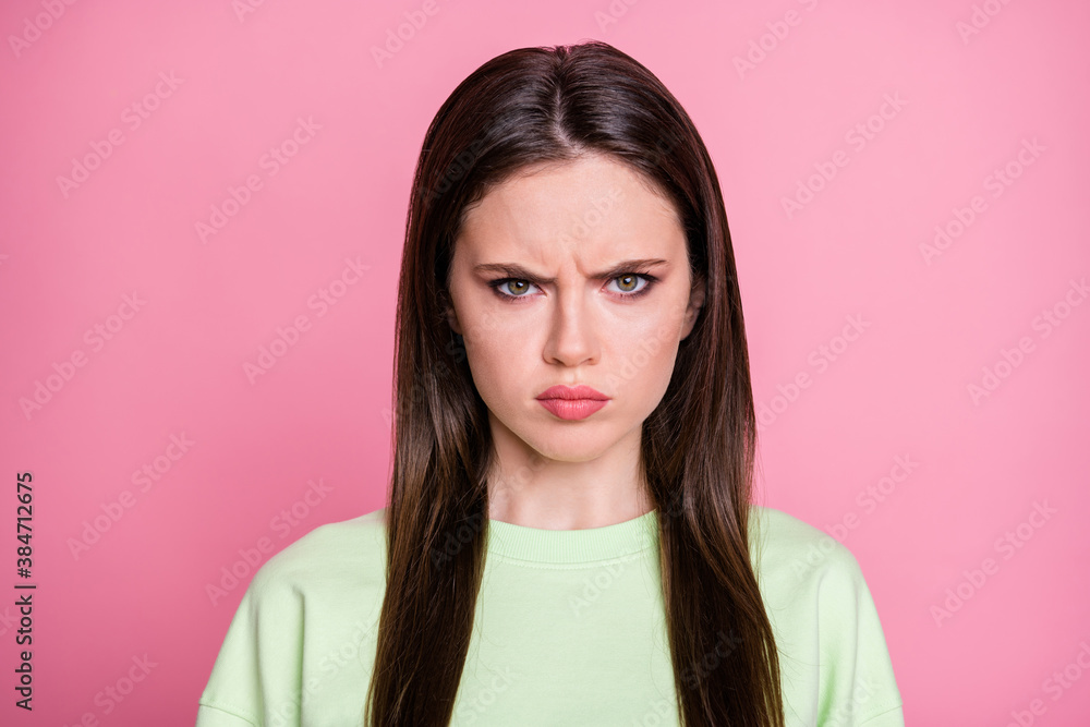 Closeup photo of attractive offended lady straight long hairdo look moody facial expression annoyed wear casual green sweatshirt pullover isolated pink pastel color background Closeup photo of attractive offended lady straight long hairdo look moody facial expression annoyed wear casual green sweatshirt pullover isolated pink pastel color background