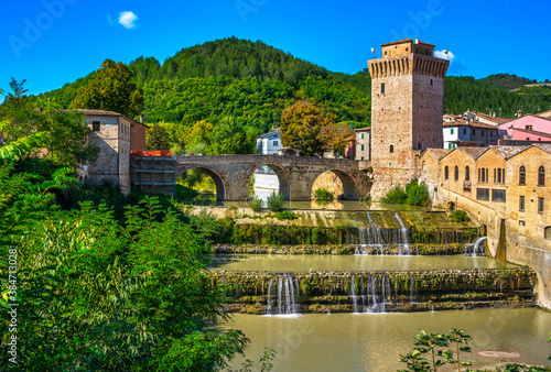 Fototapeta Naklejka Na Ścianę i Meble -  Roman bridge, medieval tower and Metauro river. Fermignano, Marche, Italy.