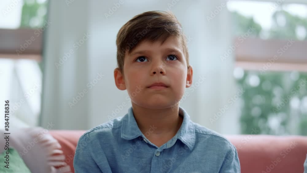 Boy playing computer game with joystick in living room. Gamer using gamepad Boy playing computer game with joystick in living room. Gamer using gamepad