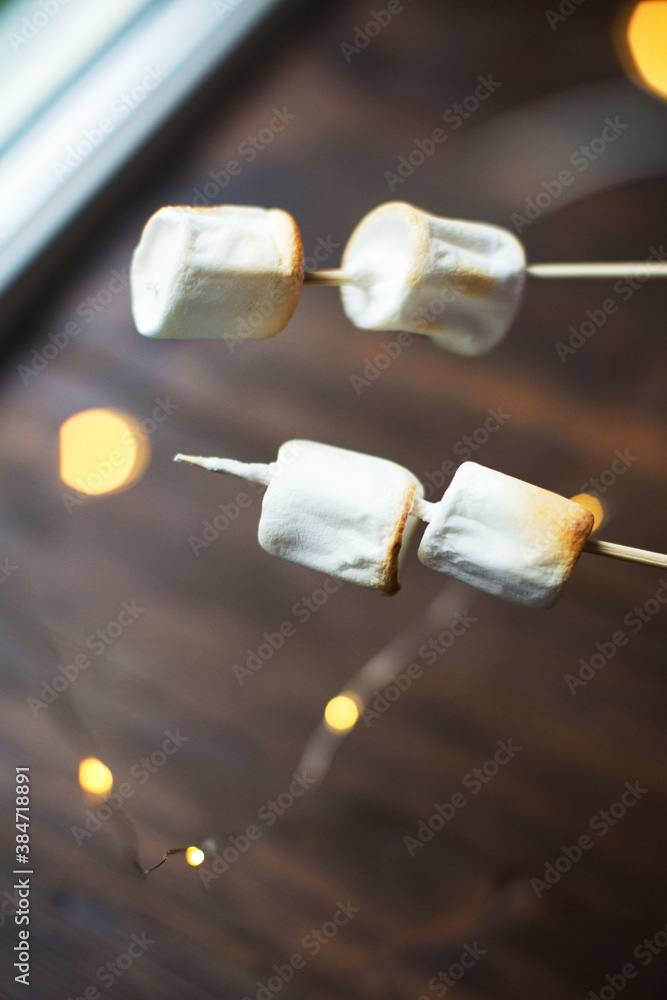 Lights and burnt marshmallows on sticks Lights and burnt marshmallows on sticks