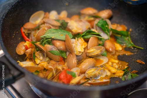 stir fried spicy clams shell with basil leaves