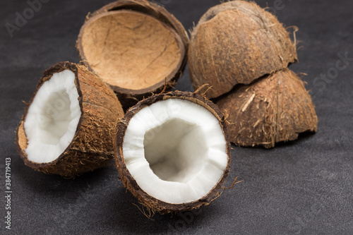 Two halves of fresh coconut and coconut shell