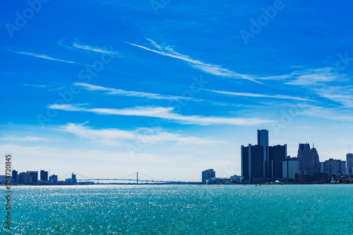 Ambassador Bridge panorama over Detroit river and city on sunny day from sunset point of Belle Isle photo