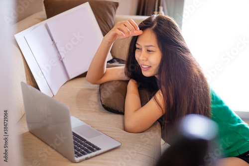 long hair asian girl smile with her laptop - Idea work from home concept