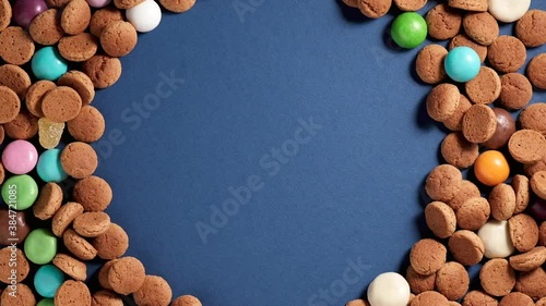 Rotation of kruidnoten, traditional sweets, strooigoed. Background for Dutch holiday Sinterklaas. St. Nicholas day concept. FullHD video, copy space, top view