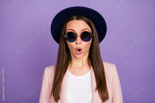 Portrait of astonished girl look good incredible wonderful sales discount information impressed open mouth wear modern pastel coat isolated over purple color background