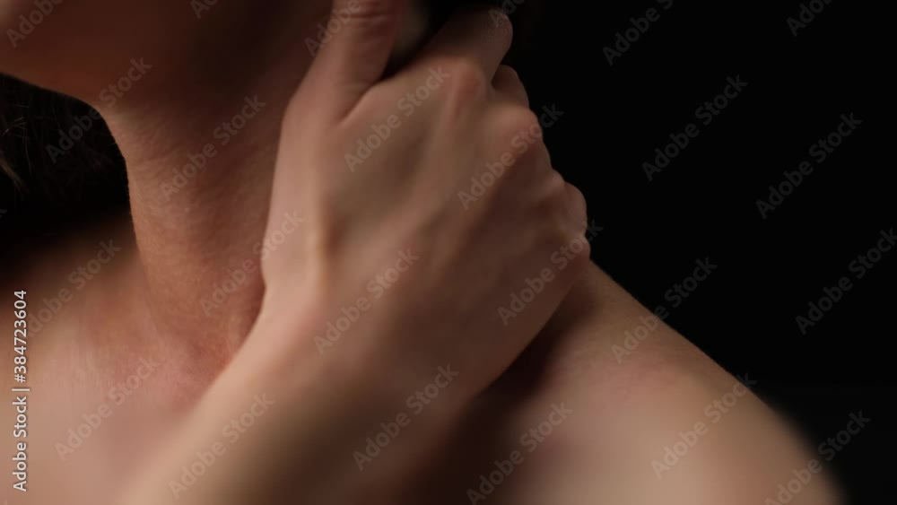 Unrecognizable woman massaging her neck due to acute pain. Unrecognizable woman massaging her neck due to acute pain.